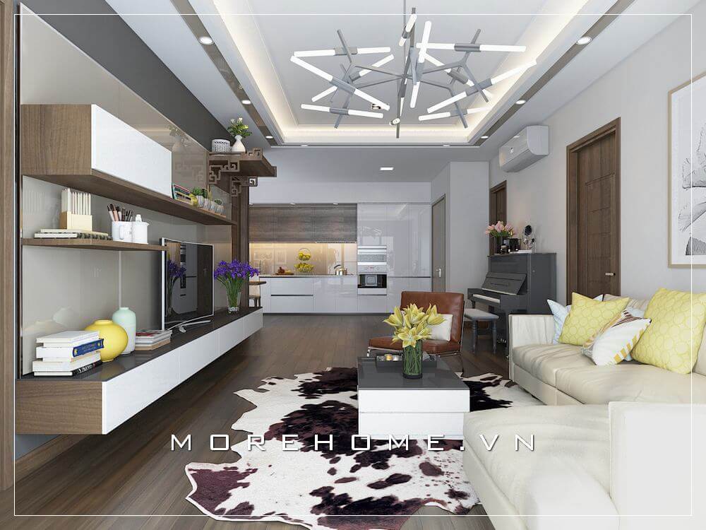 Vẻ đẹp tinh tế từ sắc trắng hiện đại kết hợp đồ nội thất gỗ óc chó cộng hưởng thêm sắc vàng, kem sữa đã tạo vẻ đẹp tinh tế cho không gian phòng khách liền bếp chung cư. Thiết kế chung cư
